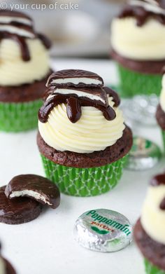 cupcakes with white frosting and chocolate decorations