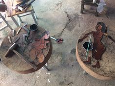 two wooden tables with painted figures on them