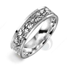 a white gold ring with flowers on the inside and outside, set in 18k white gold