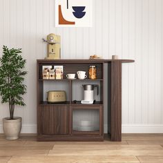 a shelf with coffee cups and other items on it next to a potted plant