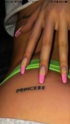 a woman with pink and green nail polish on her back, showing the word princess