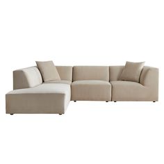 a beige sectional couch with pillows on it