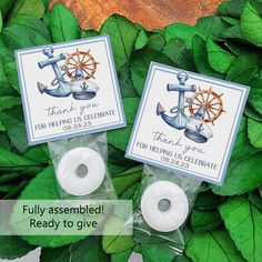 two wedding favors with anchor and wheel on them