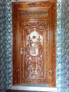 an ornate wooden door in the corner of a room