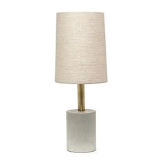 a white table lamp with a beige shade