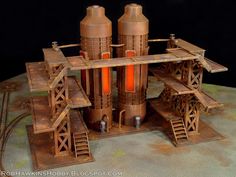 this is a model of a building made out of wood and metal with orange lights