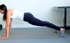 a woman is doing push ups on a mat