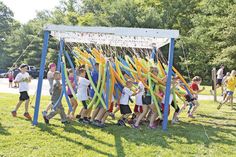 a group of kids playing with streamers in the park