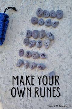 rocks spelling make your own runnies with the words written on them and a blue crocheted umbrella