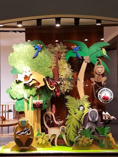 a window display with fake trees and animals