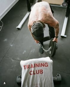 a man with no shirt on lifting a barbell