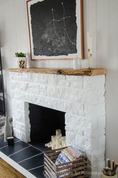 a fireplace with a chalkboard on the wall above it and candles in front of it