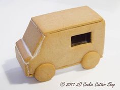 a toy truck made out of cardboard on a white surface