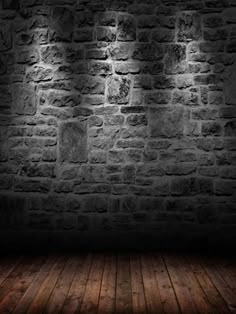 an empty room with brick walls and wooden floors, lit by lights from the ceiling