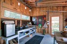 a kitchen with lots of counter space and wooden walls