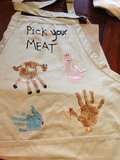 a child's apron with handprints on it that says pick your meat