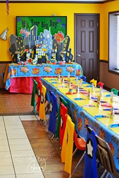 a long table set up for a birthday party with decorations on the tables and chairs