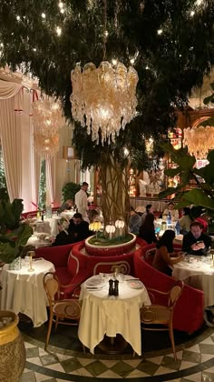 people sitting at tables in a fancy restaurant