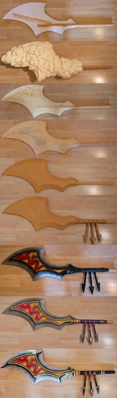 several different types of kites on display in a room with wooden floors and walls