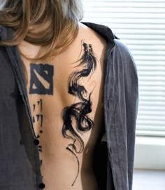 a woman with a dragon tattoo on her back