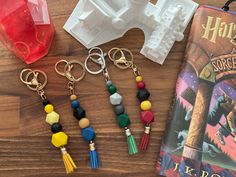 harry potter keychains are sitting on a table next to a book and an object