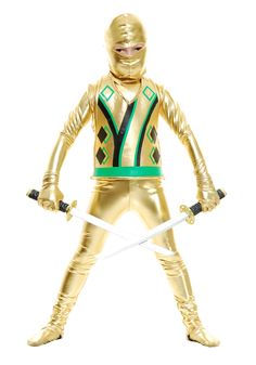 a gold colored action figure with two swords