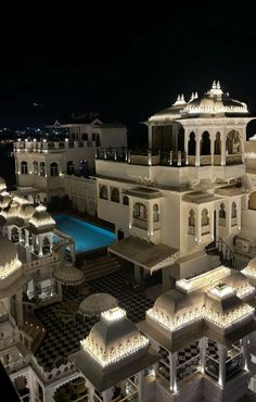 a large white building with lights on it's sides