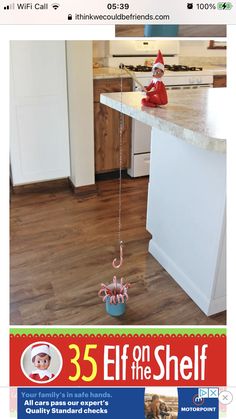 an ad for elf on the shelf with santa clause hat and candy canes hanging from it