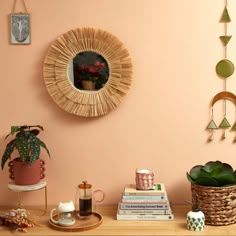 there is a shelf with some books and other items on it, along with a potted plant