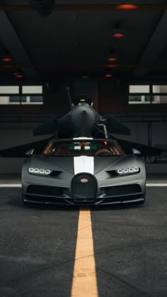 a black and white bugatti is parked in a garage