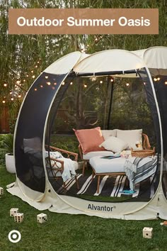 an outdoor living area with furniture and lights on the grass, surrounded by string lights