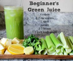 the ingredients for a green juice are displayed on a cutting board