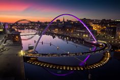 an aerial view of the city and bridge at night