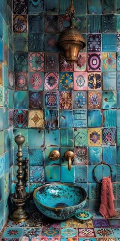 a bathroom with blue tiles and a copper faucet