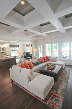 a living room filled with furniture and lots of windows