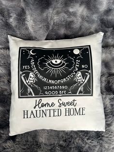 a pillow with the words home sweet and an image of a skeleton holding a sception