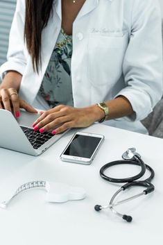 a woman sitting at a desk using a laptop computer