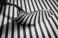 black and white striped fabric with a spoon on the table top in front of it