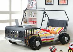 a child's bed with wheels and a laptop on it