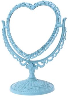 a pink heart shaped stand with an ornate design on the top and bottom, holding a candle holder