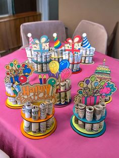 a table topped with lots of cupcakes and cake toppers on top of it