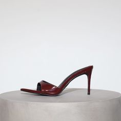 Our best selling Gia Mules reimagined in a 80 mm heel. The sexiest stilettos you'll ever own! Gia is a minimal mule that will garner all the attention. In the color of the season, Wine Patent Leather. Size and Fit Information: U.S. Sizing Available in whole and half sizes Runs true to size (Note: Not using leather and other materials from animals significantly reduces environmental impact, however, we acknowledge that synthetic alternatives are not without environmental concerns. As we grow, we Red Mules, Ankle Wrap Heels, Crystal Heels, Environmental Concerns, Wrap Heels, Instagram Handle, Environmental Impact, Black Patent Leather, Wine Red