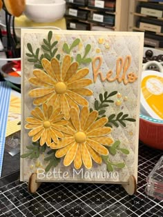 a card with yellow flowers on it and the words hello written in large letters below