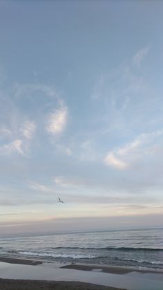 an airplane is flying over the ocean on a cloudy day with no one in sight