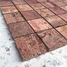 the floor is made out of red and brown tiles