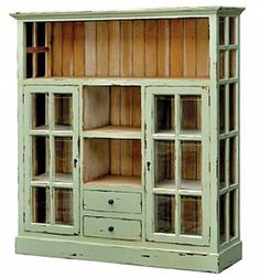 an old green bookcase with glass doors on the front and bottom, is shown