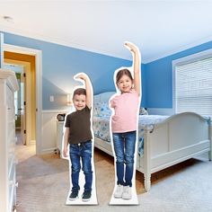 two cardboard cutouts of children standing in a bedroom