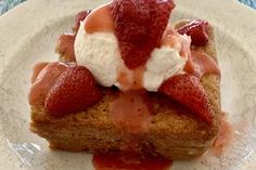 a piece of bread topped with whipped cream and strawberries