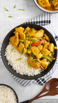 two bowls filled with rice and chicken curry