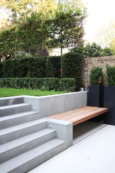 a wooden bench sitting on top of cement steps